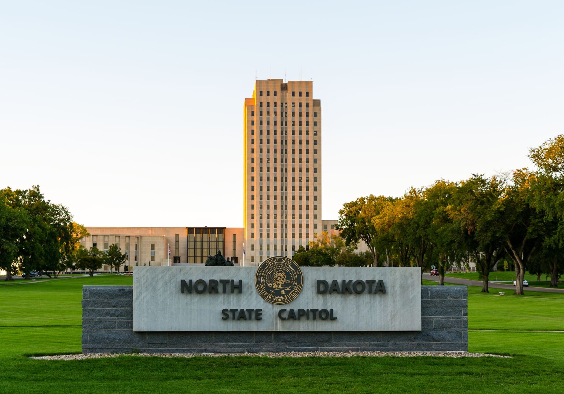 A large sign in front of a tall building.