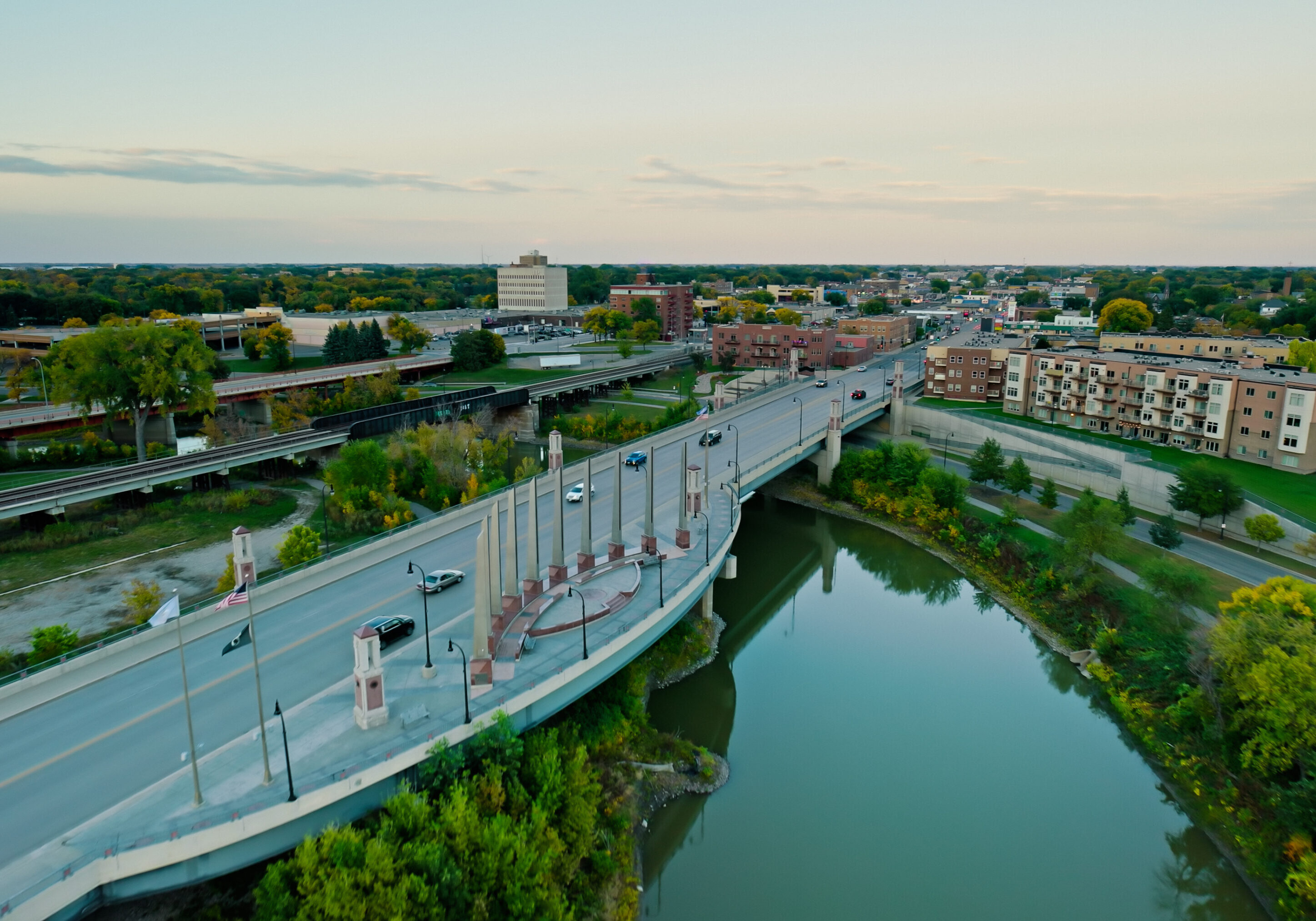 A bridge over water with trees in the background